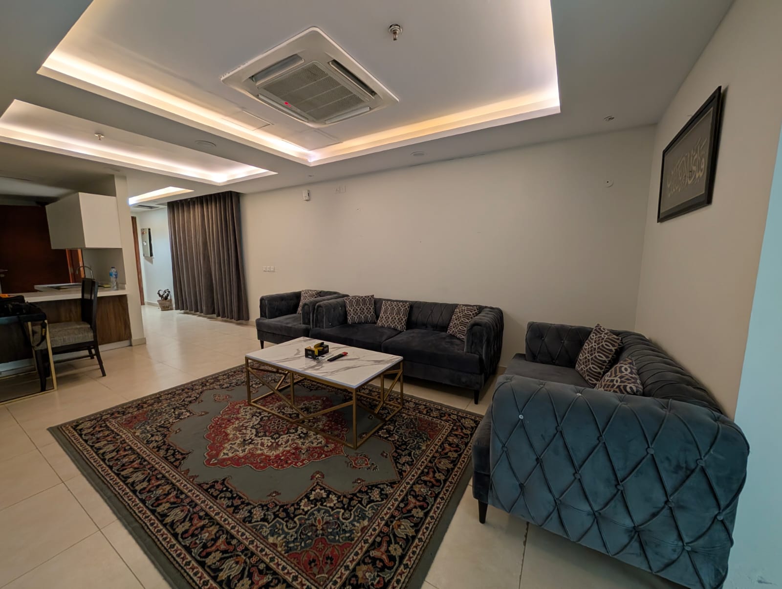 Close-up of grey diamond-tufted sofa arm